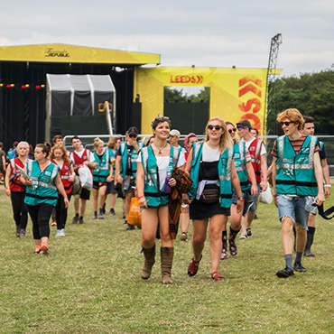 Volunteer at Leeds Festival - Arena volunteers with stage in background