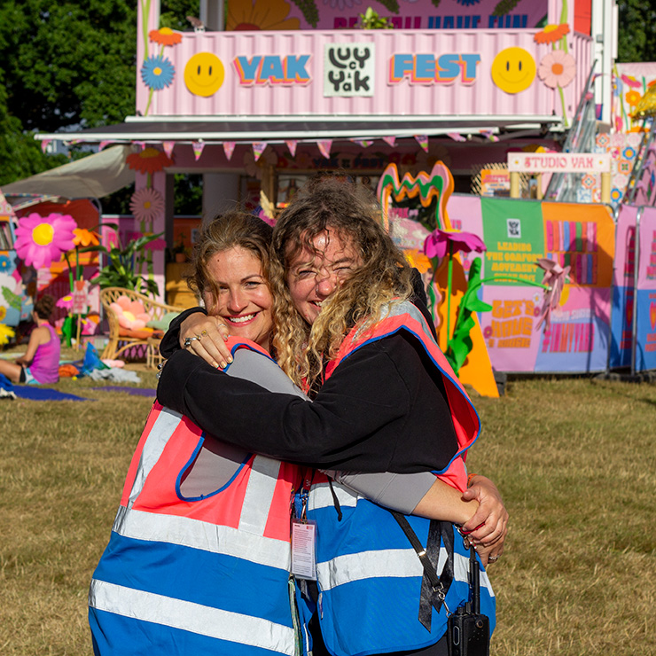 Jobs and Volunteering at Camp Bestival Shropshire with Hotbox Events - Arena volunteers hugging v2023001 740PxSq72Dpi