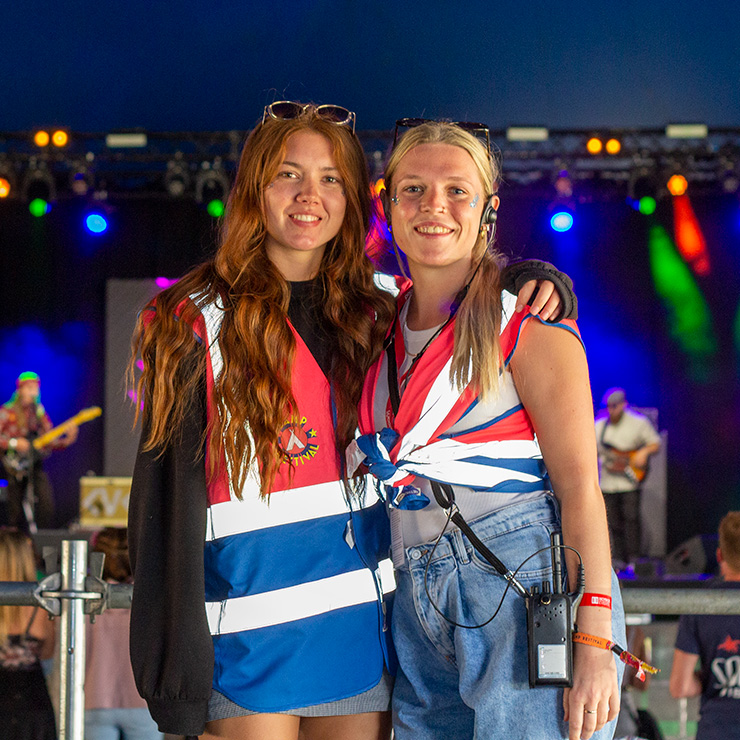 Jobs and Volunteering at Camp Bestival Shropshire with Hotbox Events - Arena volunteers in front of stage v2023001 740PxSq72Dpi