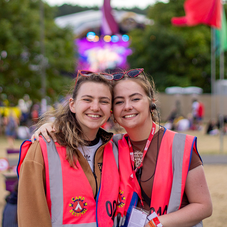 Jobs and Volunteering at Camp Bestival Shropshire with Hotbox Events - Arena volunteers smiling and hugging v2023001 740PxSq72Dpi