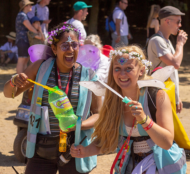 Jobs and Volunteering at Latitude Festival with Hotbox Events - Pixie volunteers laughing and blowing bubbles v2022001 740x679Px72Dpi
