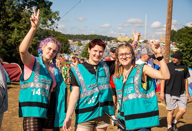 Volunteer at Leeds Festival 2022 with Hotbox Events - Campsite volunteers smiling with arms raised 2022-001 740x506Px72Dpi