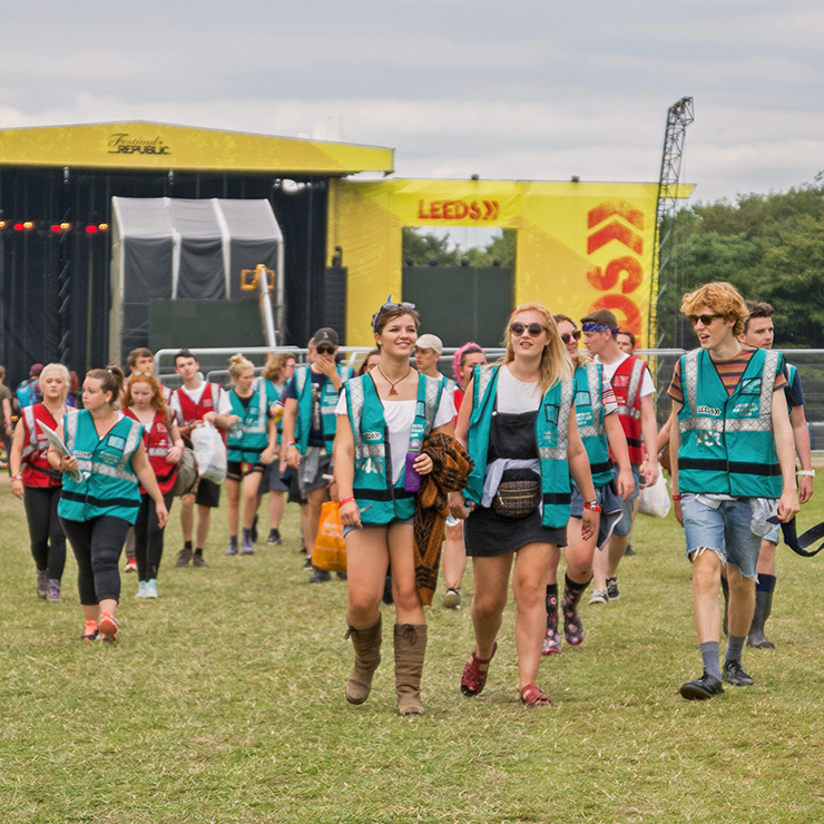 Volunteer at Leeds Festival 2022 with Hotbox Events - Volunteers walking across main arena - 2022-001 740PxSq72Dpi