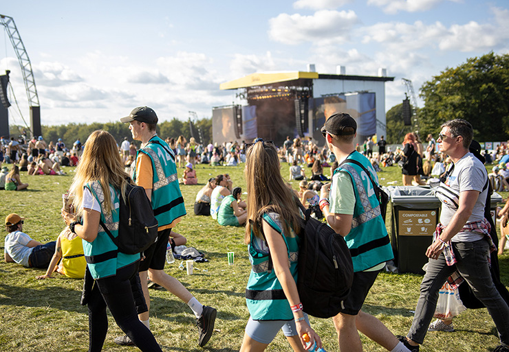 Volunteer at Music Festivals - Hotbox Events - Arena volunteers walking in front of main stage 2022-001 740x513Px72Dpi