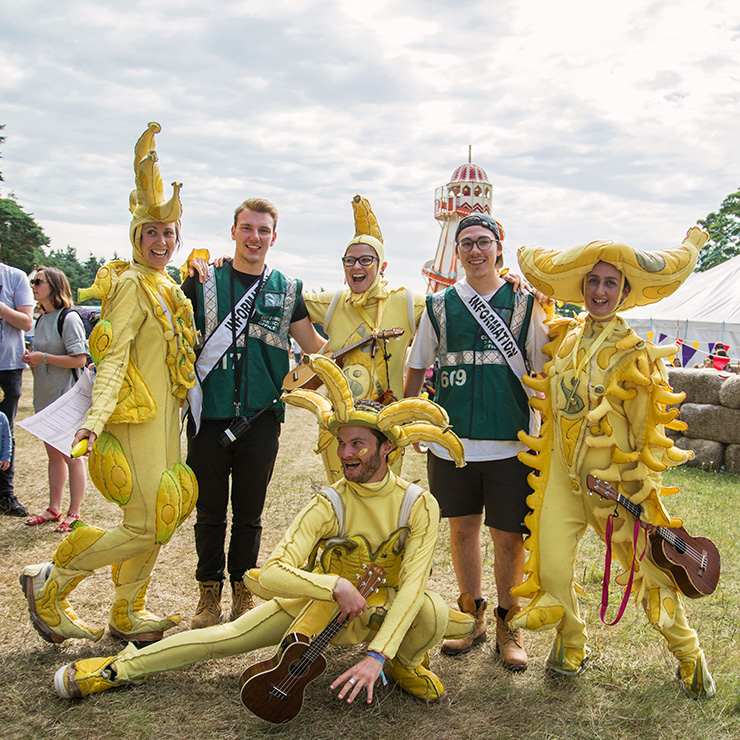 Jobs and Volunteering at Camp Bestival Dorset 2022 with Hotbox Events - Arena volunteers with banana band - 2022-001 740PxSq72Dpi