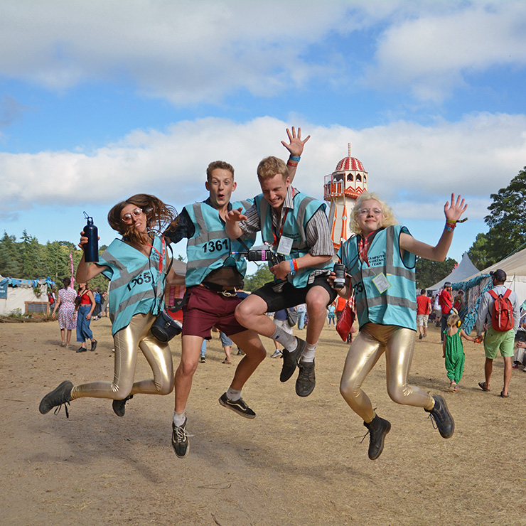 Jobs and Volunteering at Camp Bestival Shropshire 2022 with Hotbox Events - Volunteers jumping in front of helta skelta - 2022-001 740PxSq72Dpi
