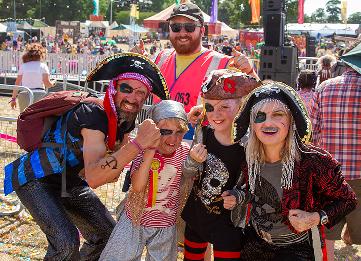 Jobs and Volunteering at Camp Bestival Dorset with Hotbox Events - Arena supervisor with festival goers in fancy dress v2023001 740x536Px72Dpi